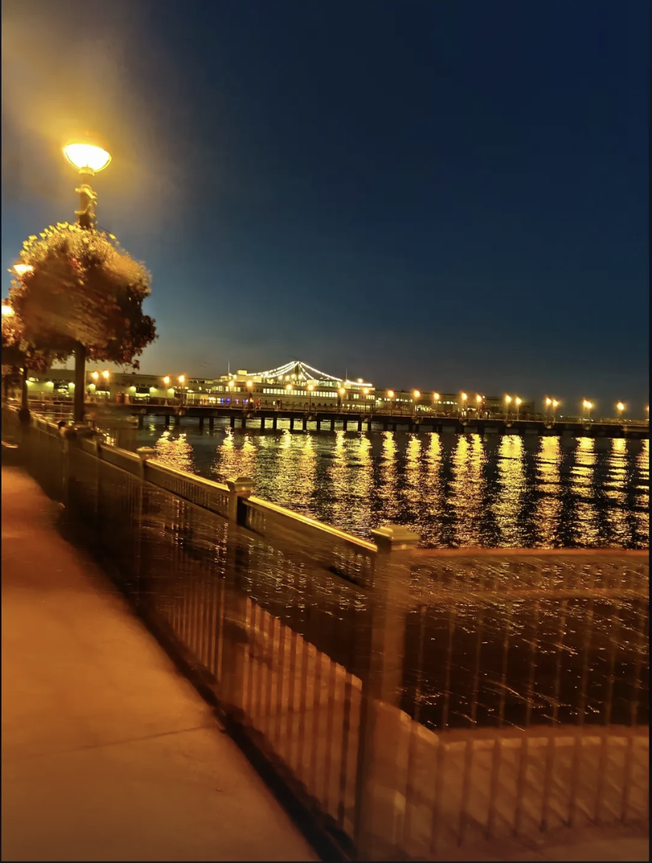 San Francisco waterfront at night with warm lights over the water